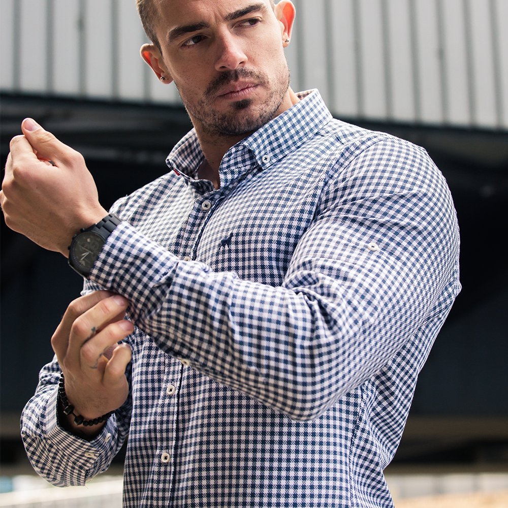 bodybuilder ash edleman in blue check shirt showing large muscles and fitted shirt