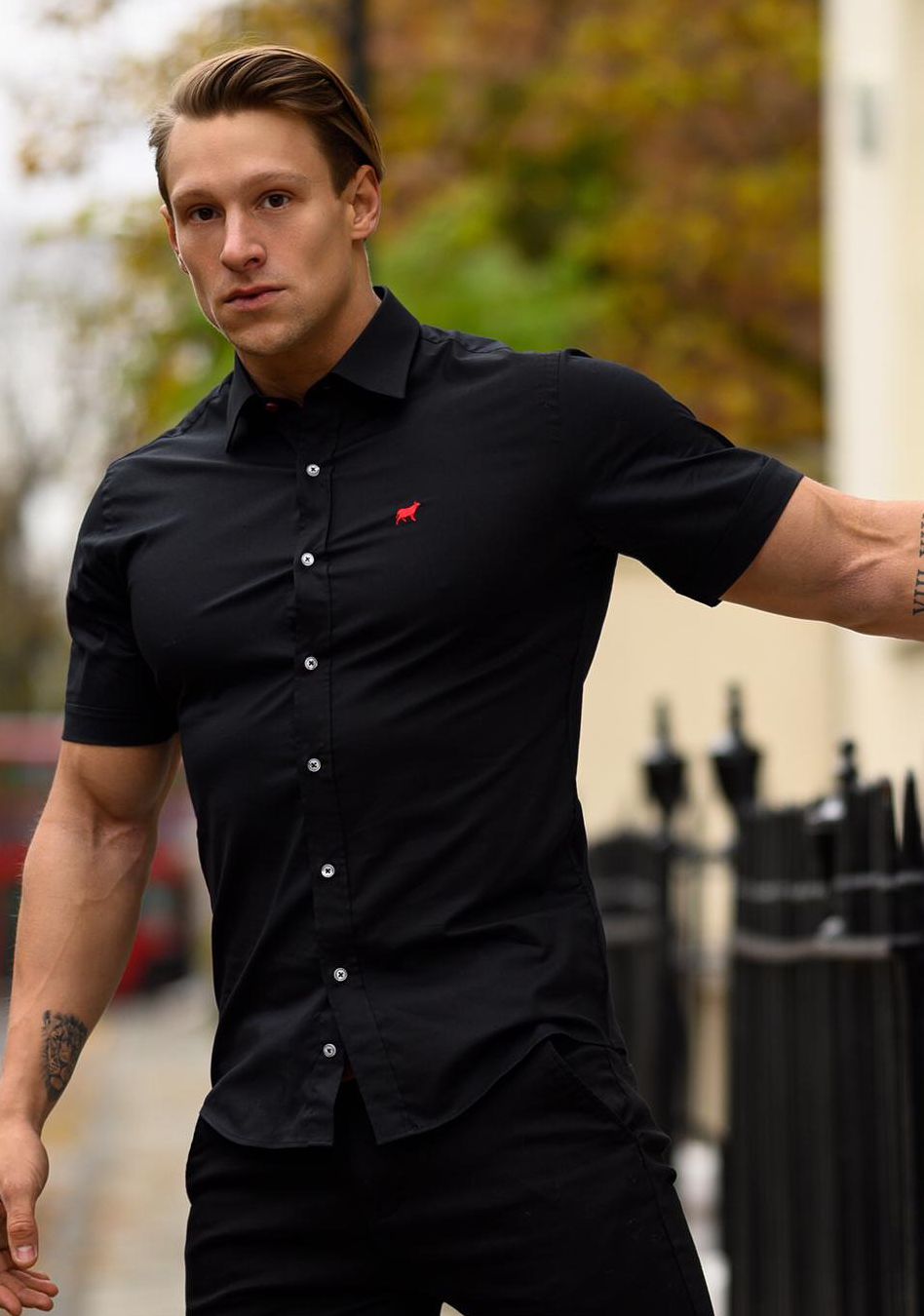Black short sleeve athletic fit shirt on an athletically built model, showcasing the muscle fit design that enhances physique, with stretch fabric for comfort and mobility