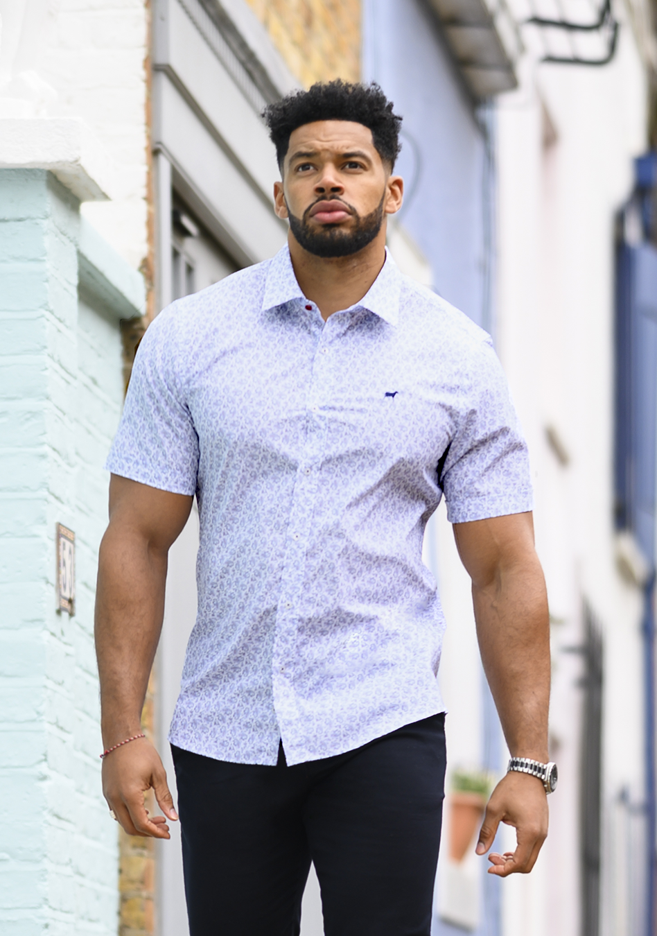 Floral short sleeve athletic fit shirt on an athletically built model, showcasing the muscle fit design that enhances physique, with stretch fabric for comfort and mobility