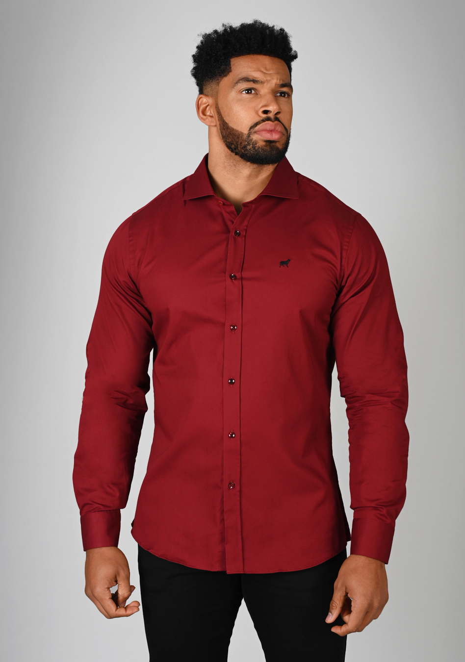 Red muscle fit shirt on an athletically built model, showcasing the athletic fit design that enhances physique, with stretch fabric for comfort and mobility