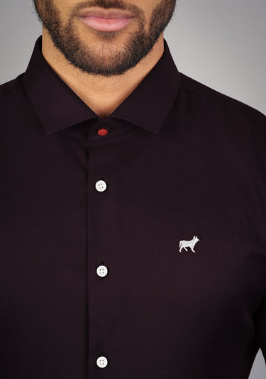 Purple athletic fit shirt on an athletically built model, showcasing the muscle fit design that enhances physique, with stretch fabric for comfort and mobility