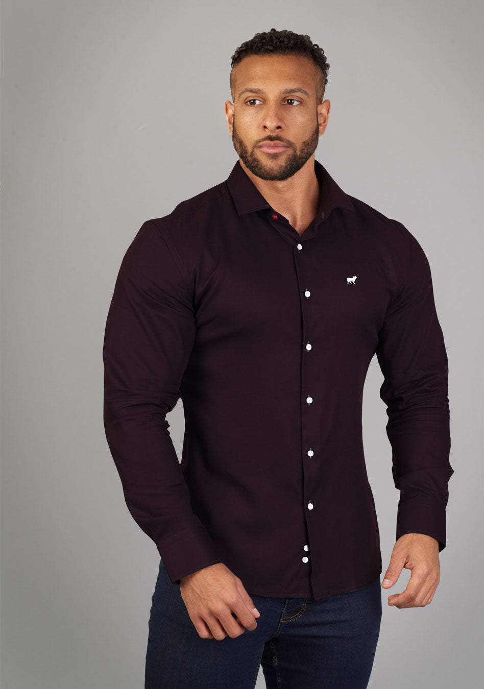 Purple muscle fit shirt on an athletically built model, showcasing the athletic fit design that enhances physique, with stretch fabric for comfort and mobility