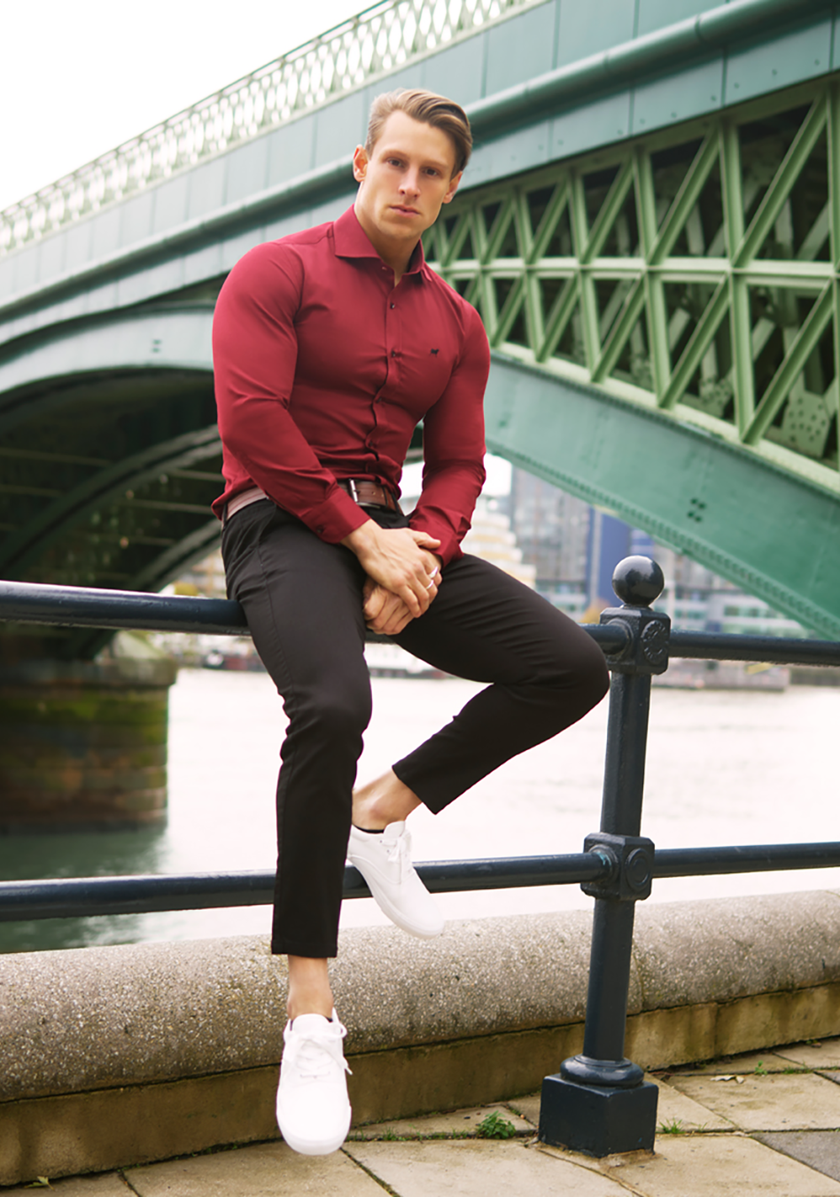 Red athletic fit shirt on an athletically built model, showcasing the muscle fit design that enhances physique, with stretch fabric for comfort and mobility