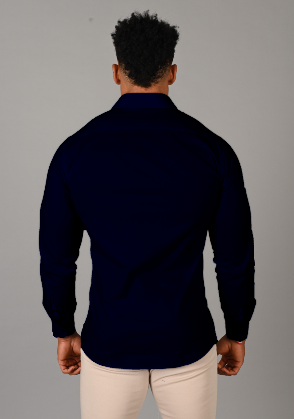 Navy muscle fit shirt on an athletically built model, showcasing the athletic fit design that enhances physique, with ultra stretch fabric for comfort and mobility