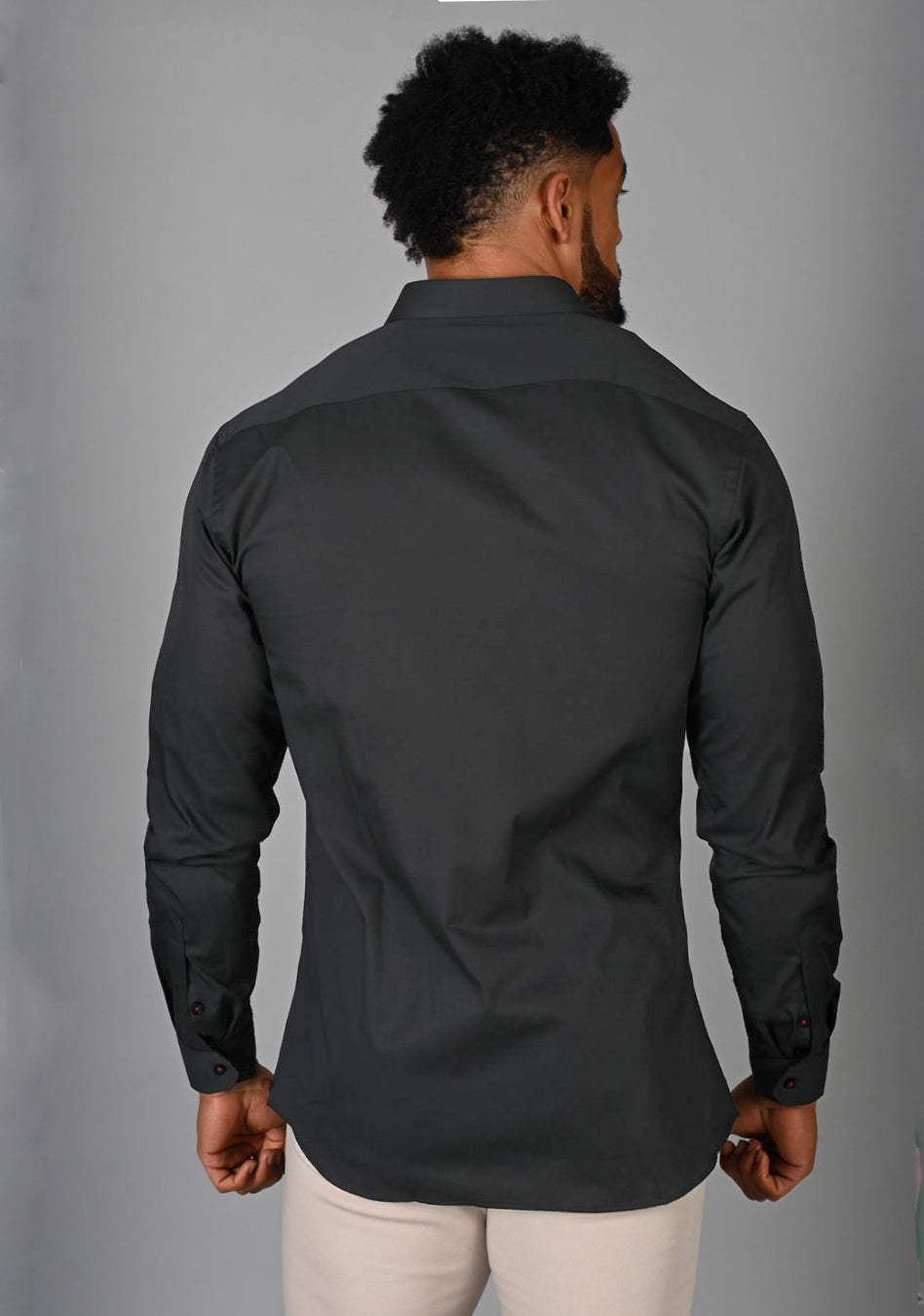 Grey athletic fit shirt on an athletically built model, showcasing the muscle fit design that enhances physique, with stretch fabric for comfort and mobility