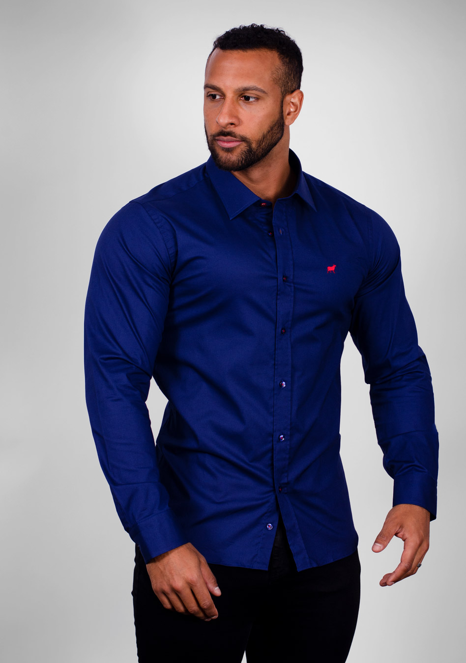Deep blue muscle fit shirt on an athletically built model, showcasing the athletic fit design that enhances physique, with stretch fabric for comfort and mobility