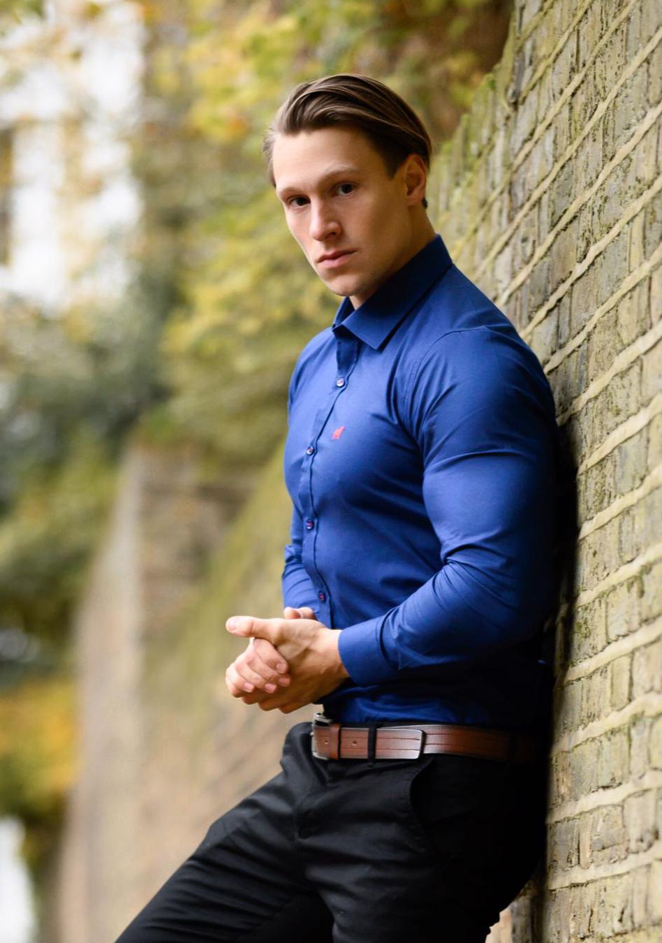 Deep blue athletic fit shirt on an athletically built model, showcasing the athletic fit design that enhances physique, with stretch fabric for comfort and mobility