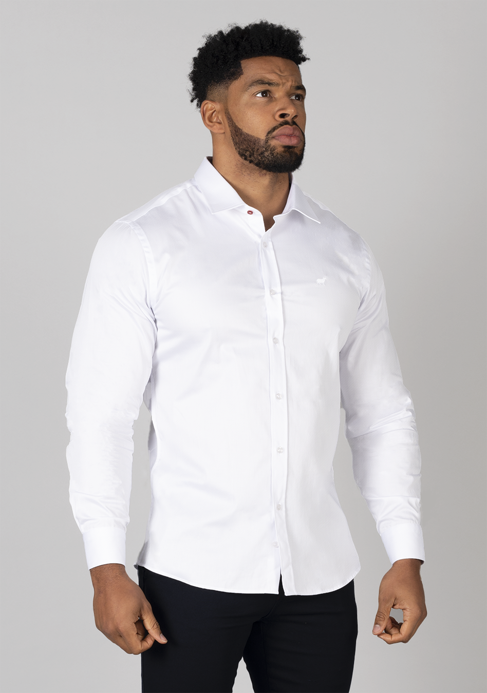 White muscle fit shirt on an athletically built model, showcasing the athletic fit design that enhances physique, with stretch fabric for comfort and mobility